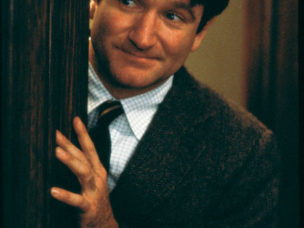 robin williams from dead poets society pearing around a door frame